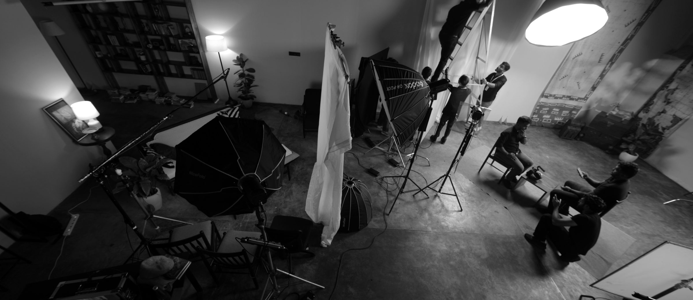 A production crew lighting an interview set in a studio