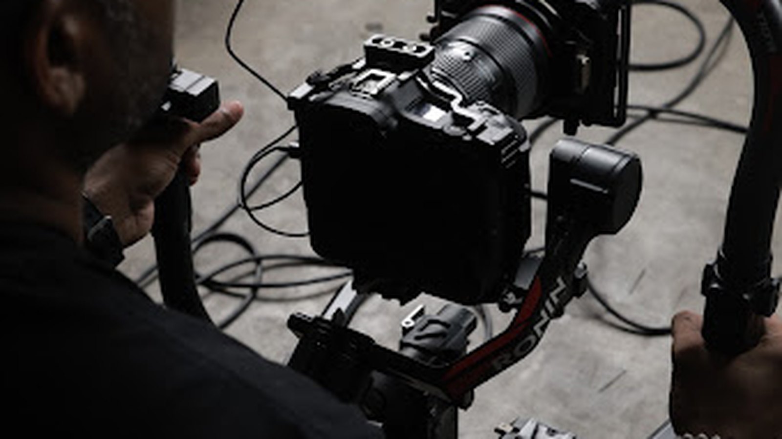 An operator with a gimbal-mounted cinema camera on set